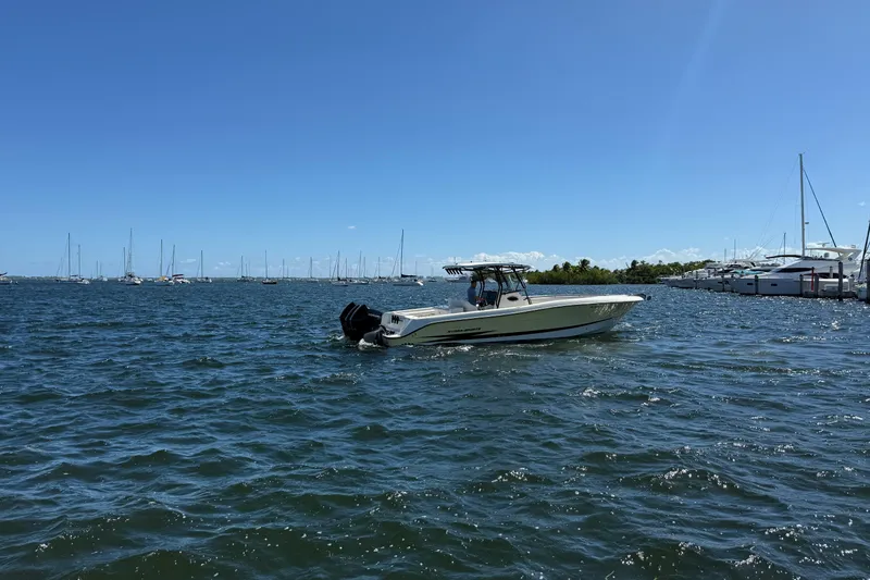 Slide: The Image of 2003 Hydra-Sports Vector 3300 CC boat cruising on a sunny day in a marina. - 3
