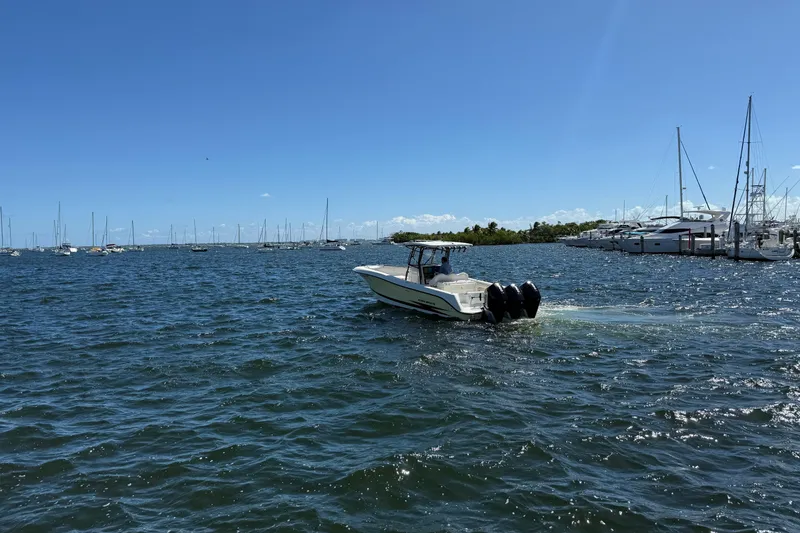 Slide: The Image of 2003 Hydra-Sports Vector 3300 CC boat cruising on a sunny day in a marina. - 4