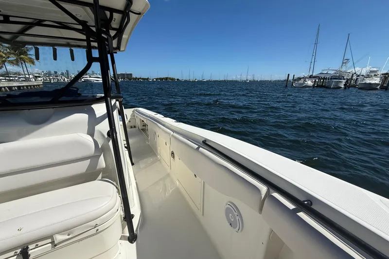 Slide: The Image of 2003 Hydra-Sports Vector 3300 CC boat on water, marina in background, sunny day. - 7