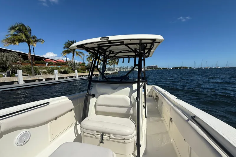 Slide: The Image of 2003 Hydra-Sports Vector 3300 CC boat on water, sunny day, palm trees in background. - 8