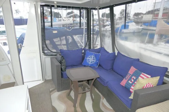 Slide: The Image of Cozy seating area on 2000 Carver 406 Motor Yacht with blue cushions and nautical decor. - 16