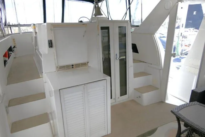 Slide: The Image of Interior of 2000 Carver 406 Motor Yacht with white cabinetry and steps. - 17