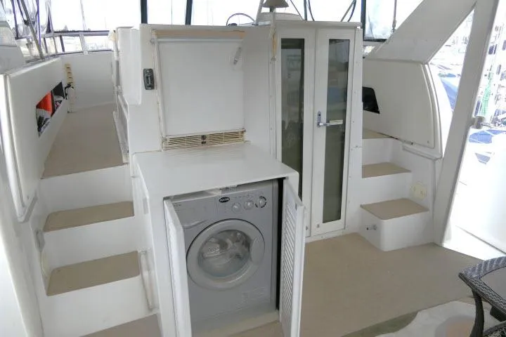 Slide: The Image of Interior of 2000 Carver 406 Motor Yacht with washing machine and storage cabinets. - 18
