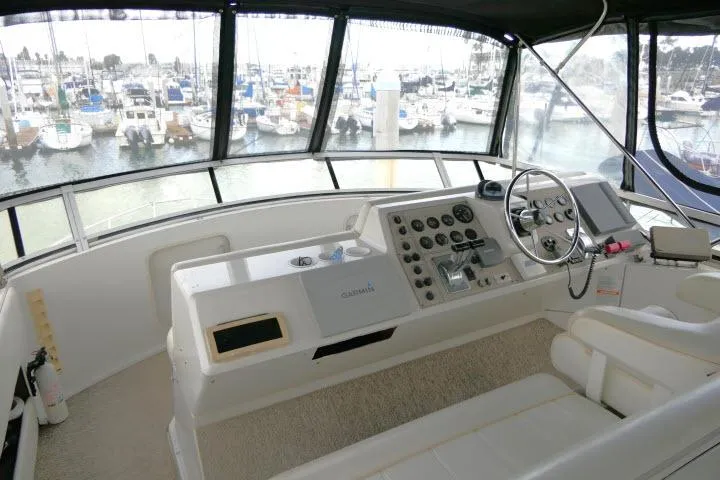 Slide: The Image of Helm of 2000 Carver 406 Motor Yacht with marina view in background. - 21