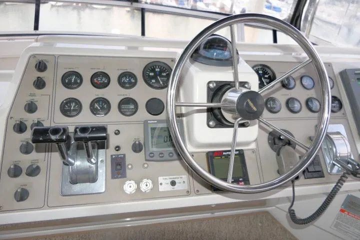 Slide: The Image of Control panel of a 2000 Carver 406 Motor Yacht with steering wheel and gauges. - 23
