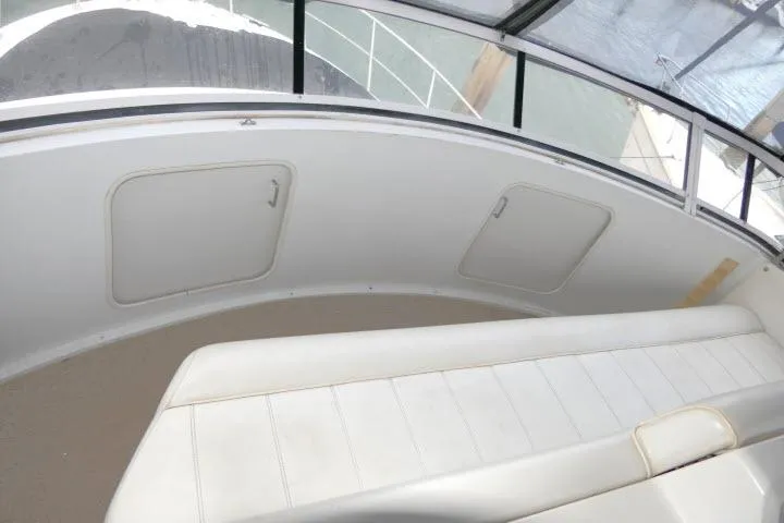 Slide: The Image of 2000 Carver 406 Motor Yacht interior with white seating and storage compartments. - 24