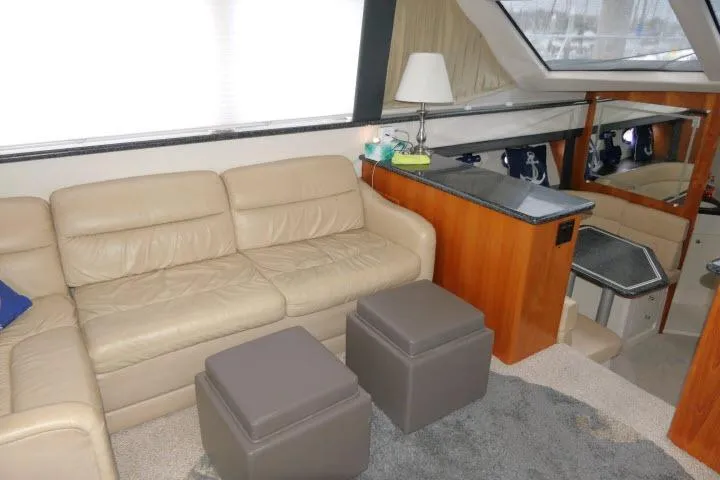 Slide: The Image of Interior of 2000 Carver 406 Motor Yacht with beige leather sofa and modern decor. - 3