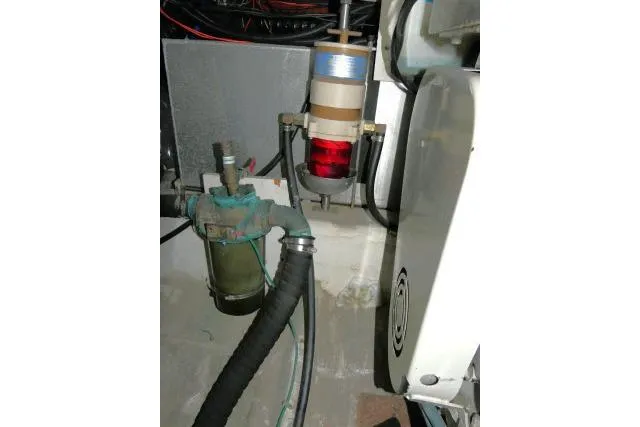 Slide: The Image of Engine room components of 2000 Carver 406 Motor Yacht, featuring filters and hoses. - 31