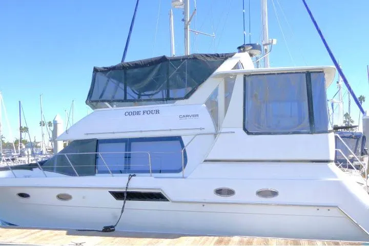 Slide: The Image of 2000 Carver 406 Motor Yacht docked at marina, side view. - 33