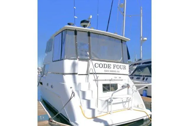 Slide: The Image of Carver 406 Motor Yacht 2000 docked, rear view with "Code Four" signage, San Diego, CA. - 35