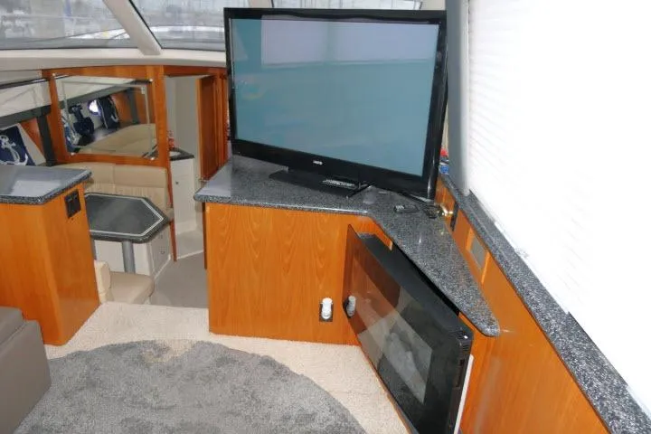 Slide: The Image of Interior of 2000 Carver 406 Motor Yacht with TV and modern furnishings. - 4