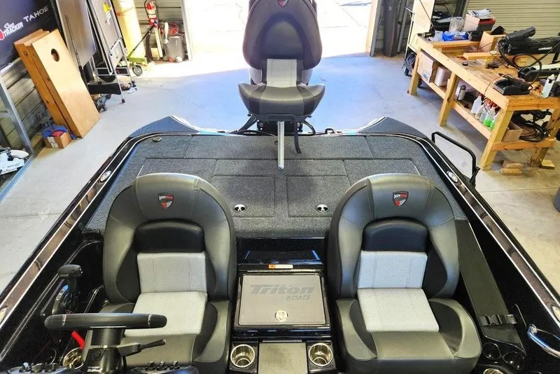 Slide: The Image of 2026 Triton 18 TrX boat interior with dual seats and steering wheel in a workshop setting. - 11