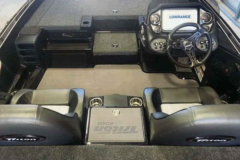 Slide: The Image of 2026 Triton 18 TrX boat interior with steering console and dual seats. - 3