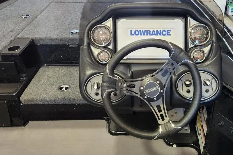 Slide: The Image of 2026 Triton 18 TrX boat dashboard with Lowrance display and steering wheel. - 4