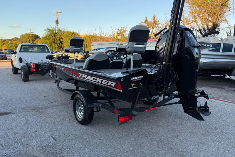 Slide: The Image of 2017 Tracker Pro Team 175 boat on trailer, attached to a white truck, in a parking lot. - 10