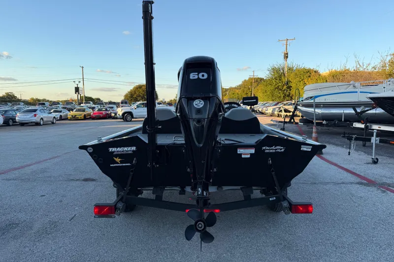 Slide: The Image of 2017 Tracker Pro Team 175 boat with 60 HP motor in a parking lot. - 11