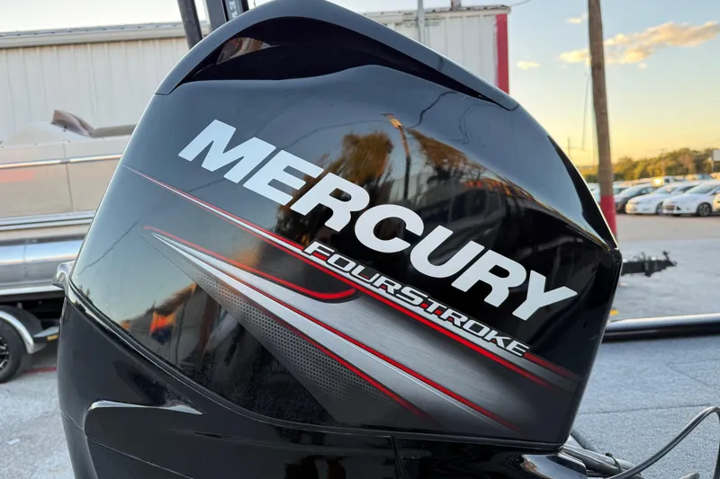 Slide: The Image of Mercury FourStroke engine on 2017 Tracker Pro Team 175 boat, parked outdoors. - 13
