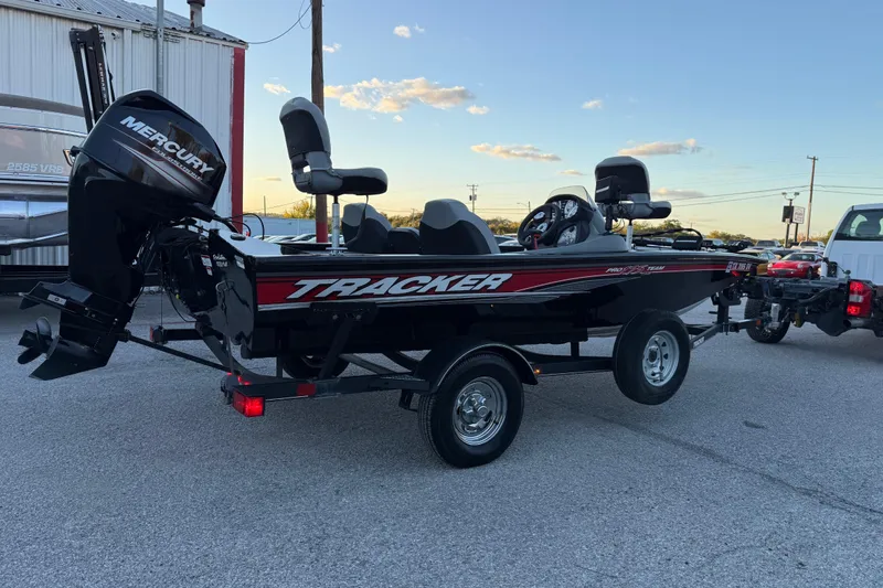 Slide: The Image of 2017 Tracker Pro Team 175 boat with Mercury engine on trailer, parked outdoors. - 14