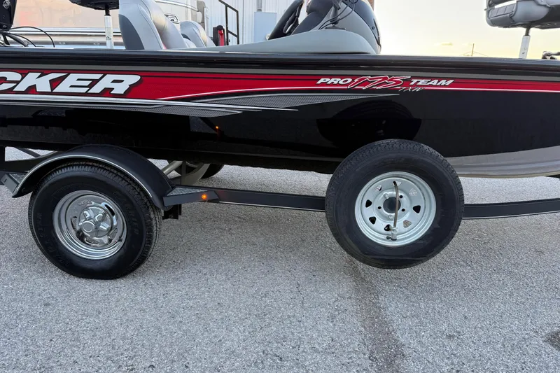 Slide: The Image of 2017 Tracker Pro Team 175 boat on trailer, side view, black and red design. - 16