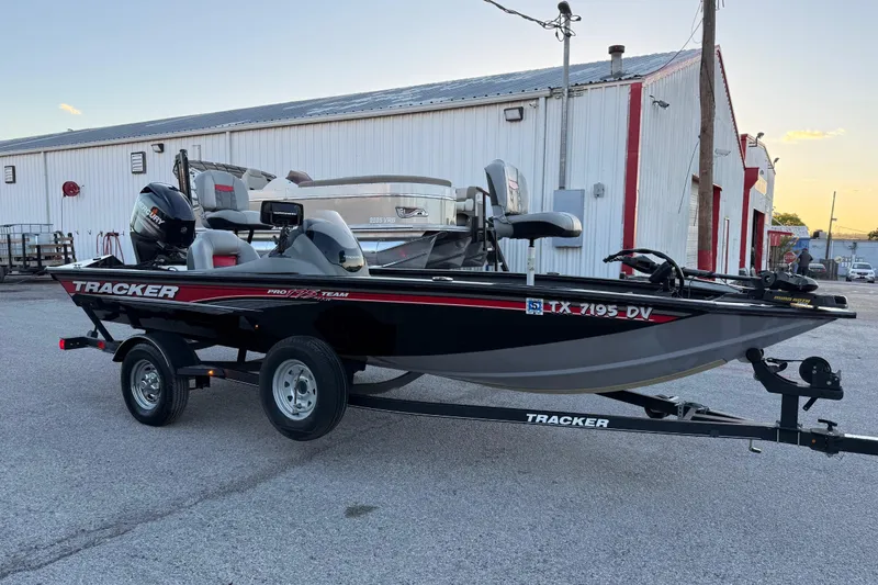 Slide: The Image of 2017 Tracker Pro Team 175 boat on trailer, parked outside a warehouse. - 17