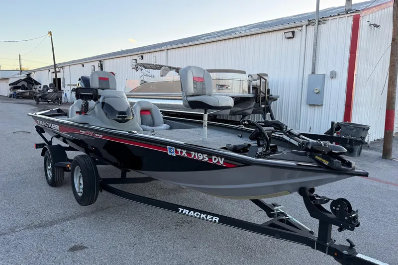 Slide: The Image of 2017 Tracker Pro Team 175 boat on trailer, parked near a warehouse. - 18