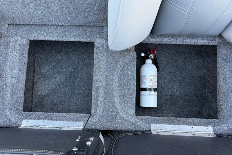 Slide: The Image of 2017 Tracker Pro Team 175 boat storage compartments with fire extinguisher. - 29