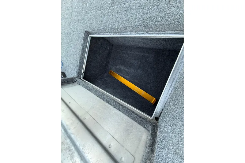 Slide: The Image of Open storage compartment in 2017 Tracker Pro Team 175 boat. - 30