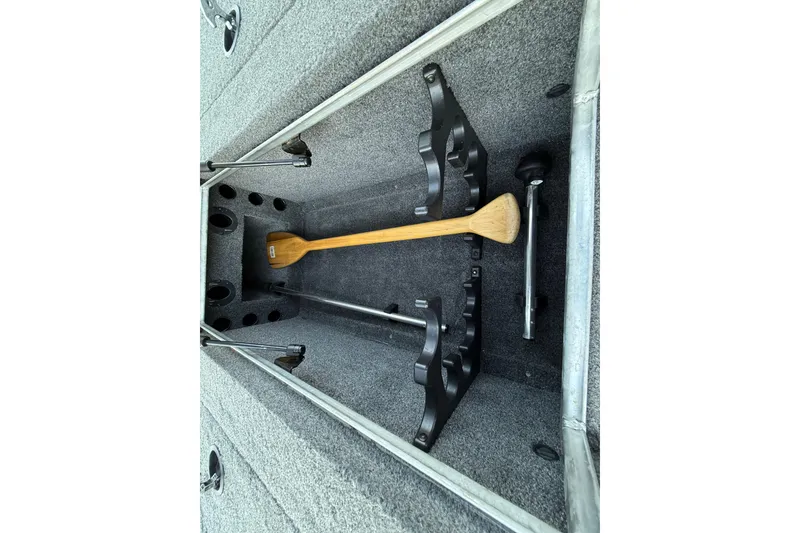Slide: The Image of 2017 Tracker Pro Team 175 boat storage compartment with paddle and rod holders. - 31