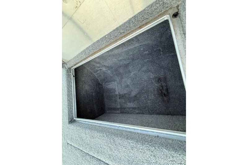 Slide: The Image of Open storage compartment in 2017 Tracker Pro Team 175 boat, carpeted interior. - 32