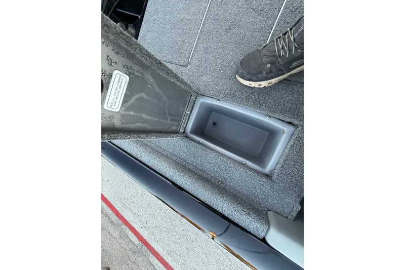 Slide: The Image of 2017 Tracker Pro Team 175 boat interior with foot pedal and carpeted flooring. - 34