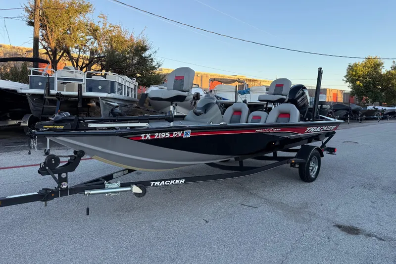 Slide: The Image of 2017 Tracker Pro Team 175 boat on trailer, parked outdoors, with seating and motor visible. - 5