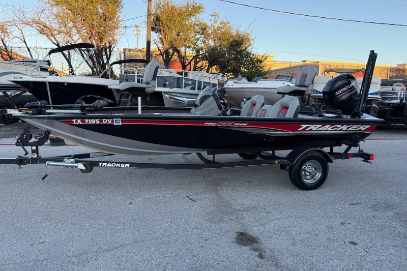 Slide: The Image of 2017 Tracker Pro Team 175 boat on trailer, parked outdoors, with visible Mercury engine. - 6