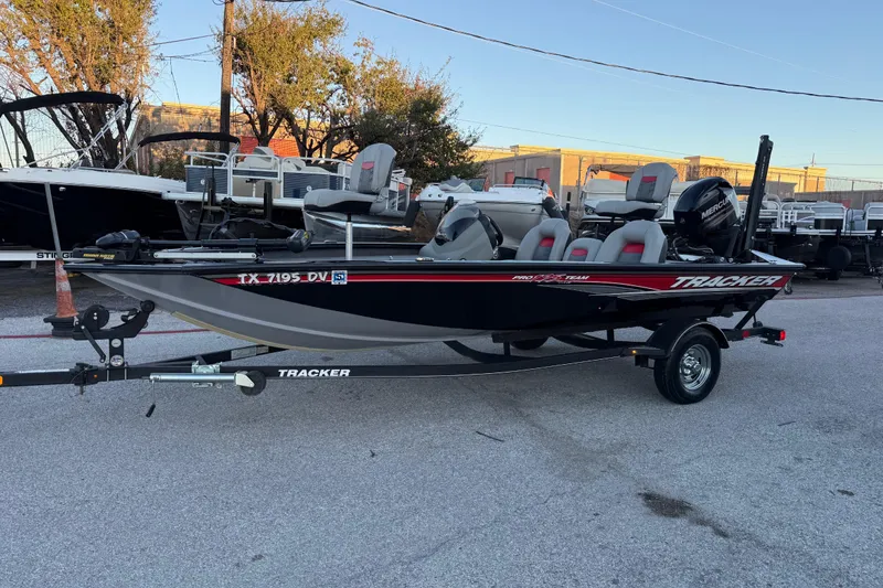 Slide: The Image of 2017 Tracker Pro Team 175 boat on trailer, parked outdoors, with visible seating and motor. - 7