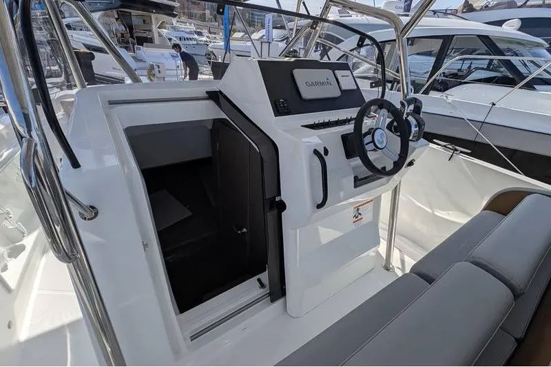 Slide: The Image of 2024 Beneteau Flyer 9 SPACEdeck helm with Garmin navigation system and seating area. - 12