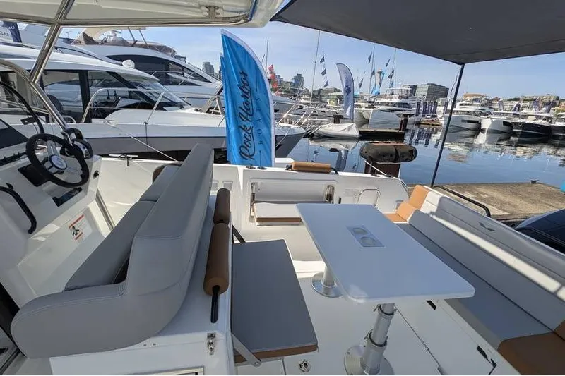 Slide: The Image of 2024 Beneteau Flyer 9 SPACEdeck at marina, featuring spacious seating and modern design. - 14