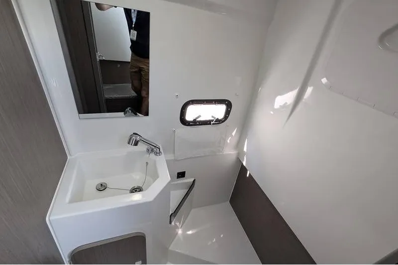 Slide: The Image of 2024 Beneteau Flyer 9 SPACEdeck bathroom with sink, mirror, and window. - 18