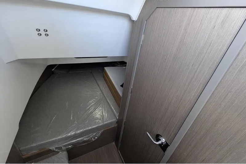 Slide: The Image of 2024 Beneteau Flyer 9 SPACEdeck cabin interior with modern wood finish and compact design. - 19