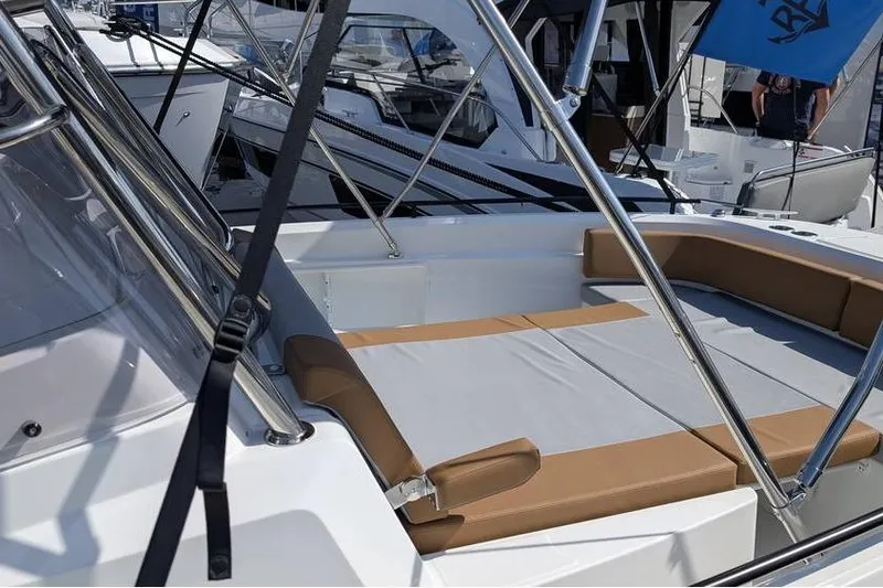 Slide: The Image of 2024 Beneteau Flyer 9 SPACEdeck boat with cushioned seating area and sleek design. - 2