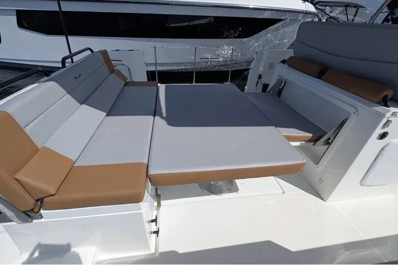 Slide: The Image of 2024 Beneteau Flyer 9 SPACEdeck seating area with cushioned benches and table. - 3