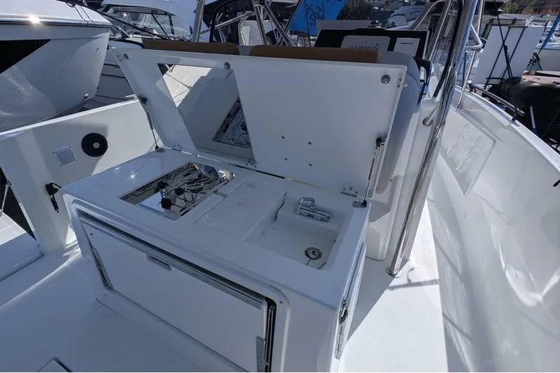 Slide: The Image of 2024 Beneteau Flyer 9 SPACEdeck boat interior with open storage compartments. - 8
