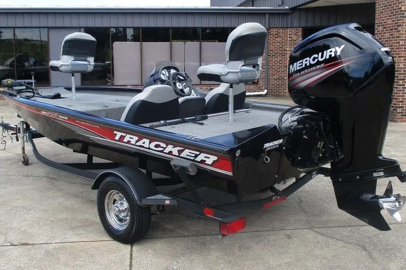 Slide: The Image of 2018 Tracker Pro Team 175 TXW fishing boat with Mercury outboard motor, parked on trailer. - 3