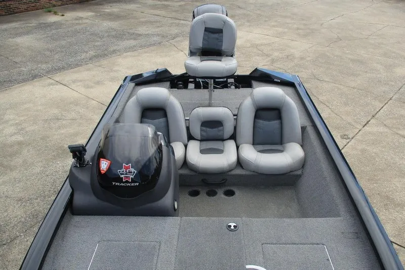 Slide: The Image of 2018 Tracker Pro Team 175 TXW boat interior with gray seating and steering console. - 4