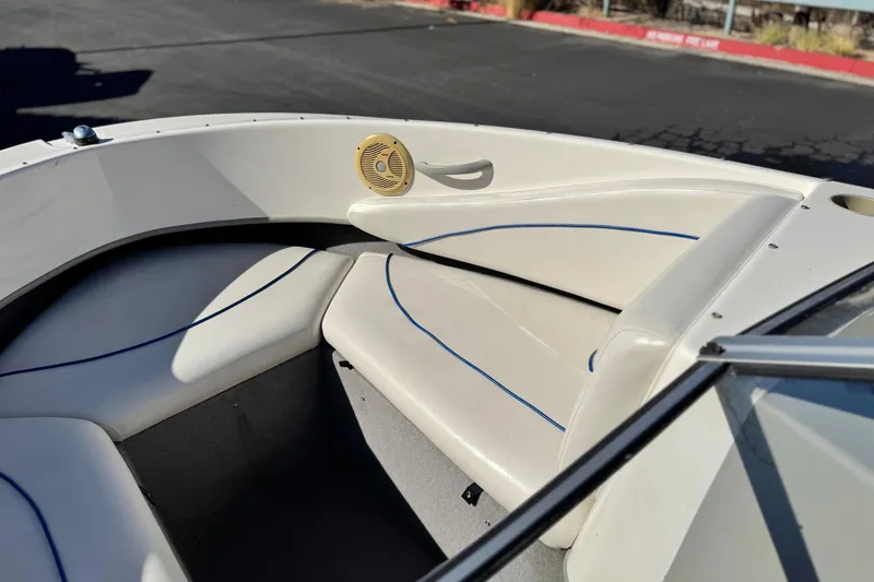 Slide: The Image of 2006 Bayliner 215 Bowrider interior with white seating and blue accents. - 11