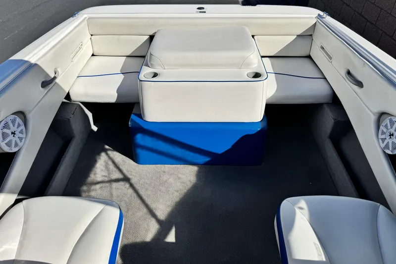Slide: The Image of 2006 Bayliner 215 Bowrider interior with white seating and blue accents. - 13