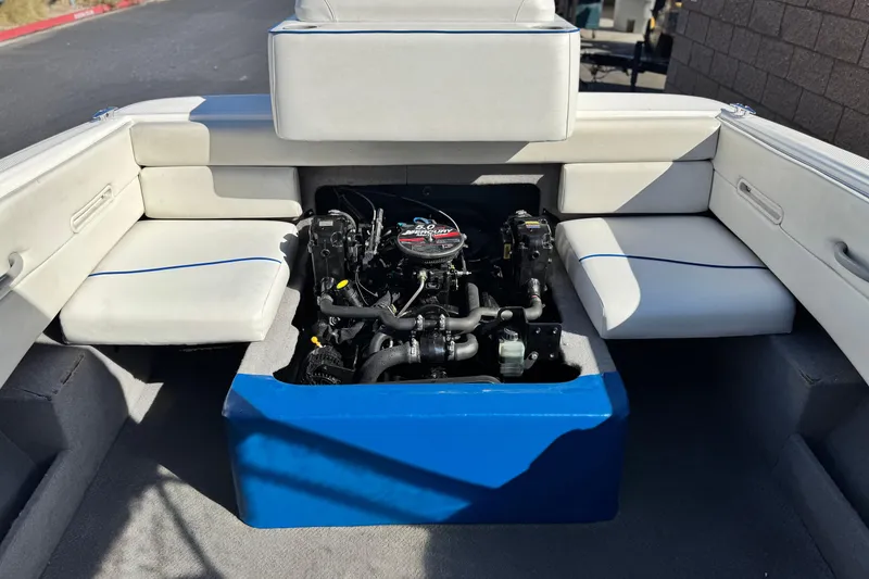 Slide: The Image of 2006 Bayliner 215 Bowrider boat interior showing engine compartment and seating area. - 14