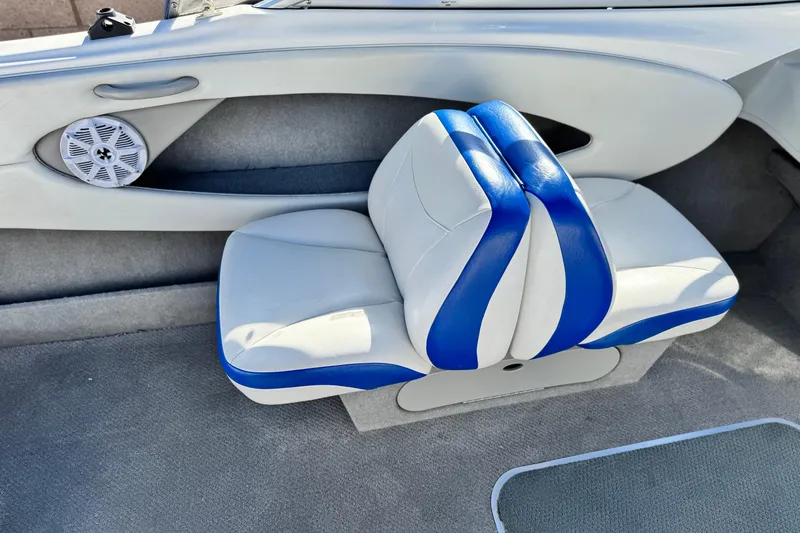 Slide: The Image of 2006 Bayliner 215 Bowrider interior with blue and white seating and speaker. - 16