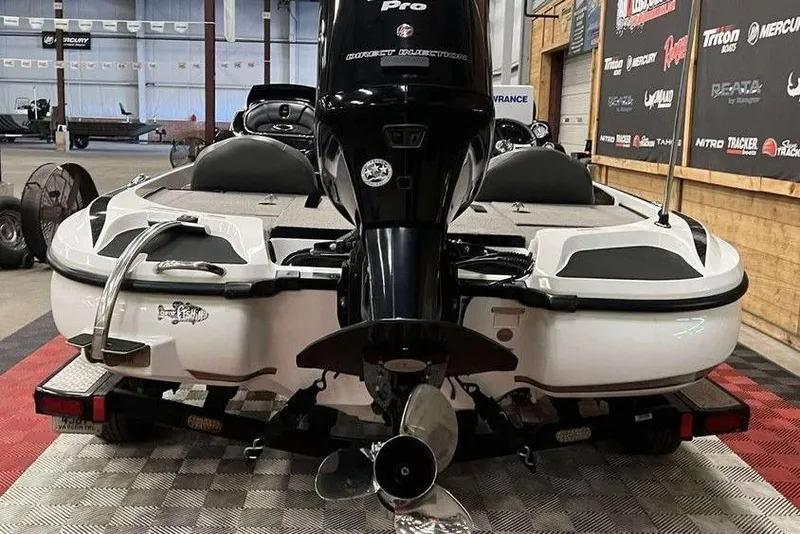 Slide: The Image of 2016 Nitro Z18 boat on trailer, featuring powerful outboard motor in showroom. - 3