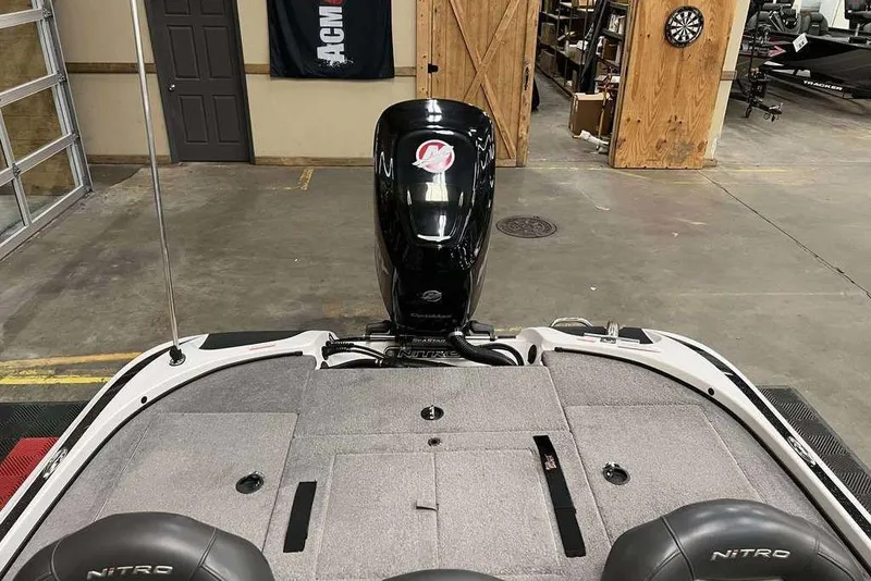 Slide: The Image of 2016 Nitro Z18 boat interior with motor, in a garage setting. - 5