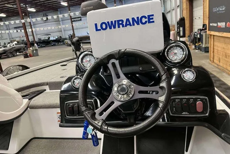Slide: The Image of Steering wheel and dashboard of a 2016 Nitro Z18 boat with Lowrance Elite display. - 6