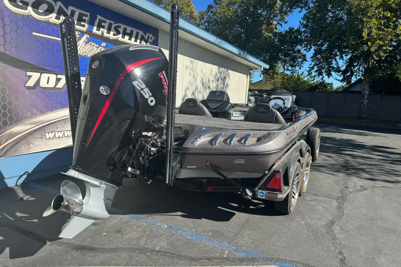 Slide: The Image of 2020 Ranger Z521C Ranger Cup Equipped boat with powerful outboard motor, parked outdoors. - 2